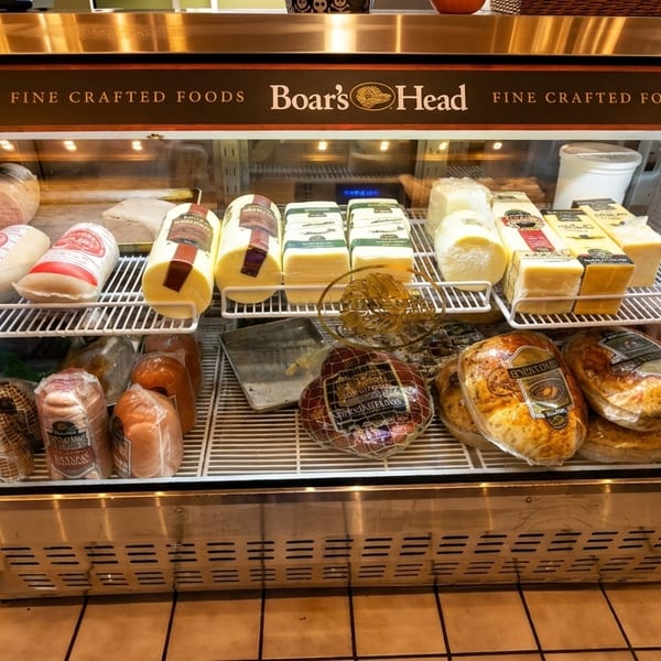 Boar's Head deli case filled with various cheeses, meats, and other fine crafted foods.